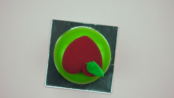 Bright and Colorful Cake Heart  on a Pink Background. Rotating Top View.