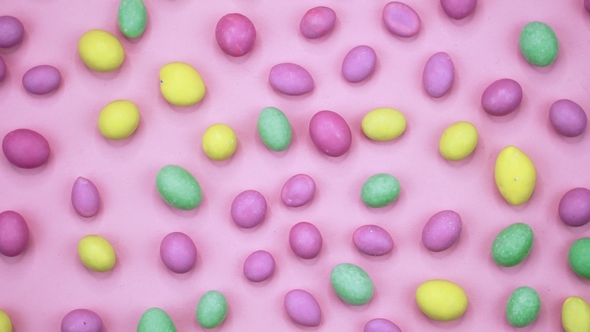 Video of Tasty Crispy Round Candies Isolated on Pink Background. Yellow, Orange, Green, Pink and