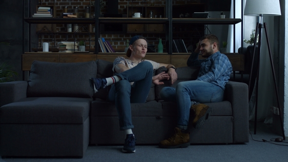 Relaxed Hipster Friends Chatting on Couch at Home