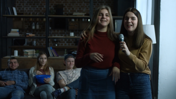 Joyful Girls Singing Karaoke in Domestic Room