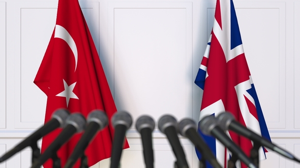 Flags of Turkey and The United Kingdom at International Press Conference alt