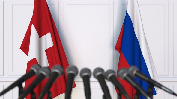 Flags of Switzerland and Russia at International Press Conference alt