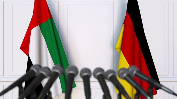 Flags of the UAE and Germany at International Press Conference alt