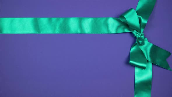 Two Silk Ribbons Form a Bow in the Corner. Festive Background for Advertising. Stop Motion
