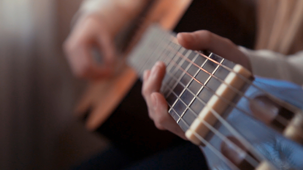 Young Girl Playing the Guitar