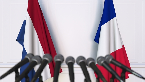 Flags of the Netherlands and France at International Press Conference alt