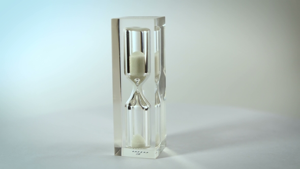 Modern Glass Hourglasses Rotate Against a White Background
