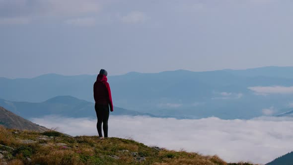 Woman Standing in Mountain Peak