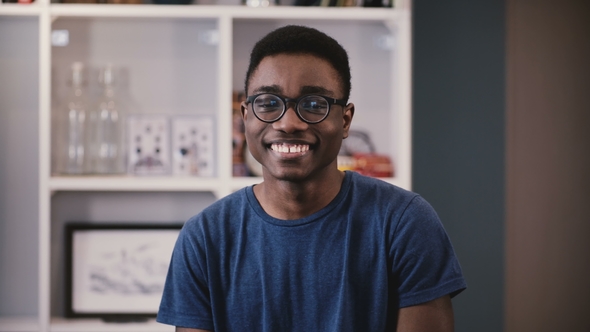  Happy Black Young Guy in Glasses Smiles, Then Becomes