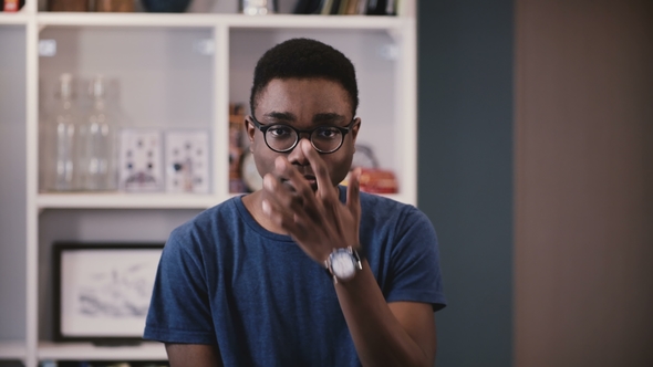 Portrait of Serious African American Student. Handsome Thoughtful Black Young Man Adjusting Glasses