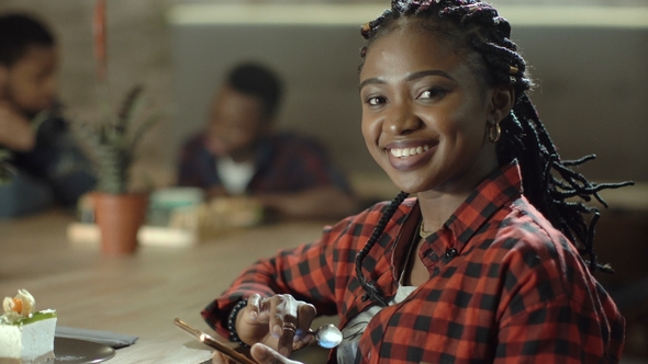 Portrait of Smiling Black Woman in Cafe