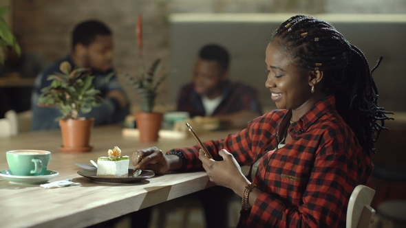 Woman Spending Time in Cafe Using Phone