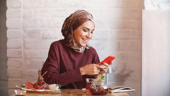 Happy Muslim Woman Using Mobile Phone.