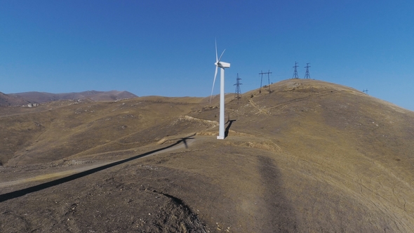 Green Energy Windmill Turbine Rotating at Farm