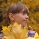 Teenage Girl Holding Maple Autumn Leaves and Smiling - VideoHive Item for Sale
