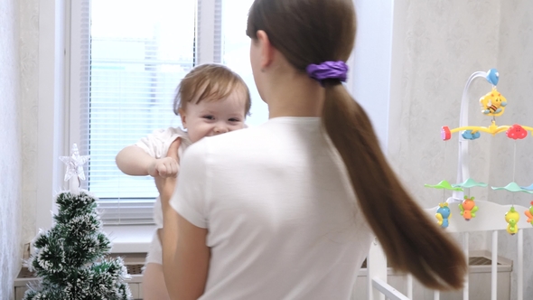 Mom Plays with Her Child in the Children Room