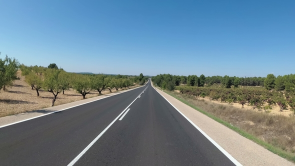 Motorcyclist Rides on a Beautiful Landscape Desert Scenic and Empty Road in Spain