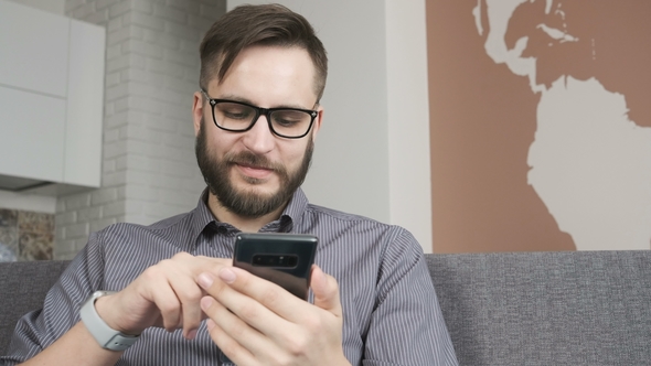 Man Paying Online by Bank Card at Smartphone