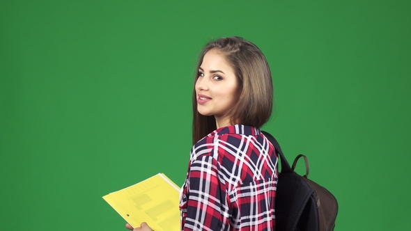 Gorgeous Cheerful Female Student Smiling Over Her Shoulder