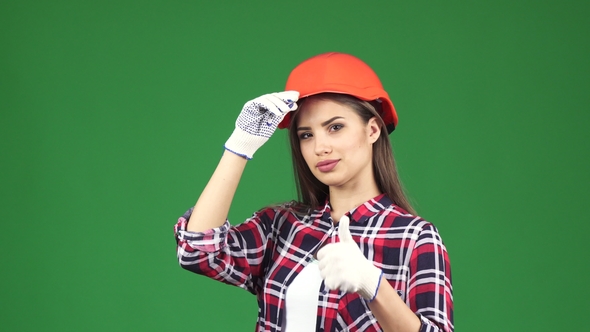 Sexy Young Female Contractor Wearing Hardhat Showing Thumbs Up