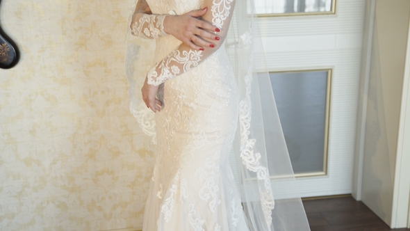 Beautiful Bride Poses and Smiles at Camera in the Luxurious Apartments