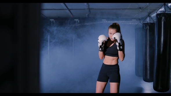 Woman Kickboxer Shadow Boxing As Exercise for the Fight
