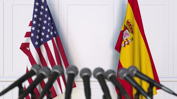 Flags of the USA and Spain at International Press Conference alt