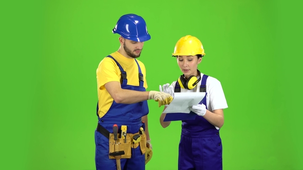 Designer Girl Shows a Sketch of a Building To a Builder