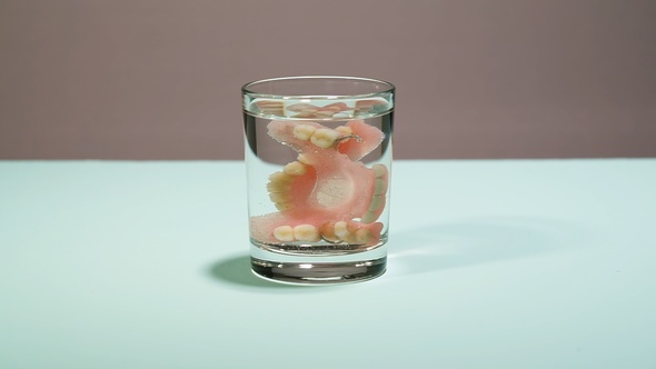 False Teeth In A Glass Of Water