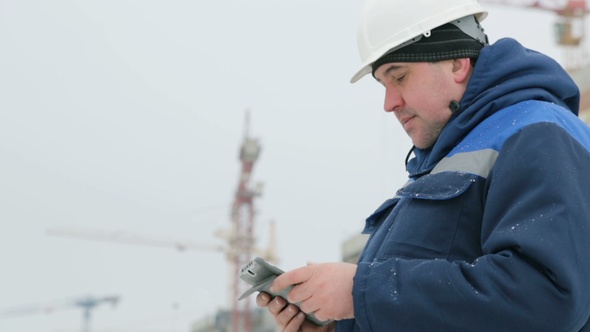 Foreman With Pad at Major Construction Project