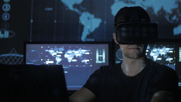 Man Hacker Programmer Uses a Virtual Reality Helmet for Programming