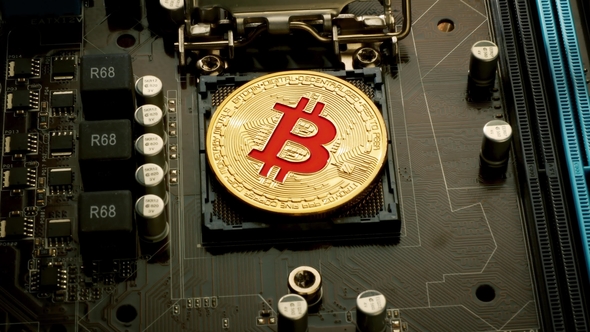 Gold Bit Coin BTC Coins on the Motherboard Bitcoin Is a Worldwide Cryptocurrency