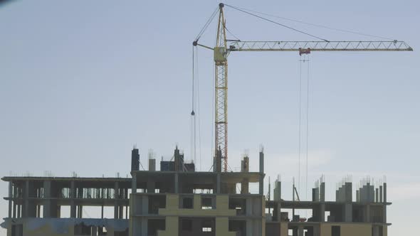 Timelapse Construction Site Crane Is Lifting a Precast Concrete Wall Panel to Installation Building alt