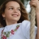 Cute Little Girl with Beautiful Long Hair Enjoying the Summer Wind, While Sitting on a Wooden Swing - VideoHive Item for Sale