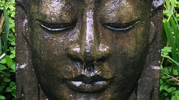 Buddha with Falling Water in the Tropical Garden in Ubud, Bali