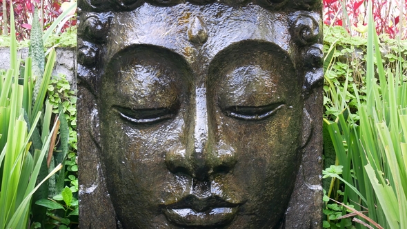 Buddha with Falling Water in the Tropical Garden in Ubud, Bali.