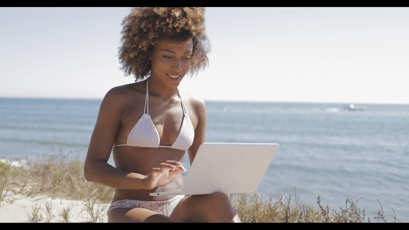 Pretty Girl with Laptop on Beach