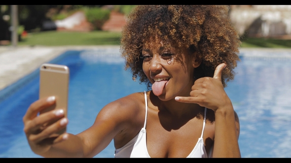 Girl Grimacing for Selfie in Pool