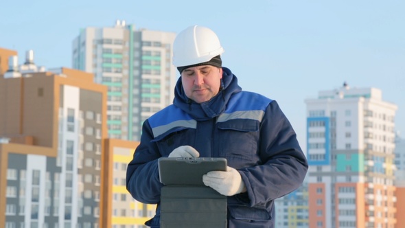 Foreman With Tablet Computer at Major Construction Project