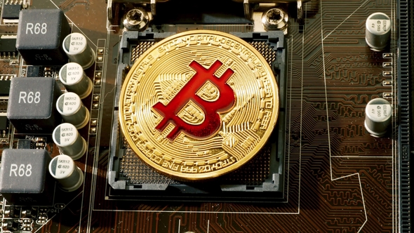 Gold Bit Coin BTC Coins on the Motherboard Bitcoin Is a Worldwide Cryptocurrency