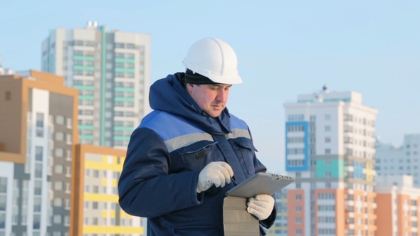 Foreman With Tablet Computer at Major Construction Project