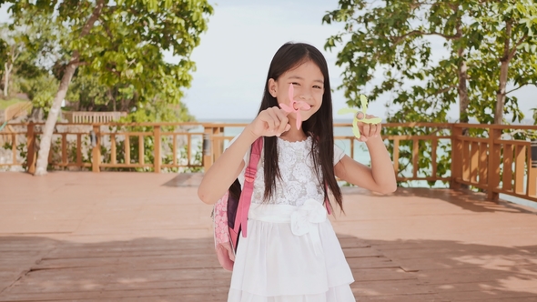 A Small Philippine Schoolgirl Shows Spinning Spinners