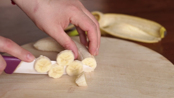 on Woman Cutting Banana on Cutting Board