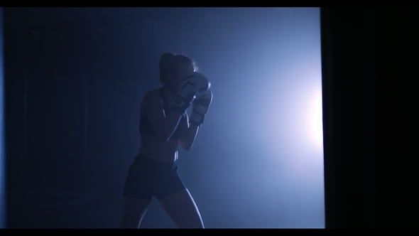 Silhouettes of a Boxer in a Dark Smoky Room