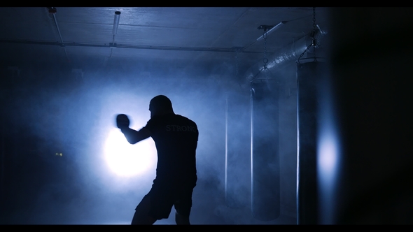 Boxer Workout in a Boxing Club. Silhouette