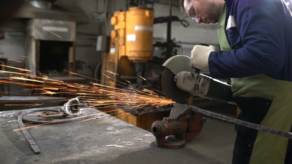 Brutal Man in Working Clothes and Apron Saws Circular Electric