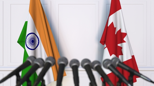 Flags of India and Canada at International Press Conference alt