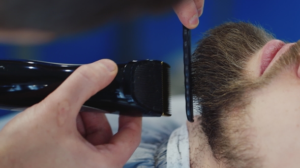 Men's Hairstyling and Haircutting in a Barber Shop or Hair Salon. Grooming the Beard. Barbershop.