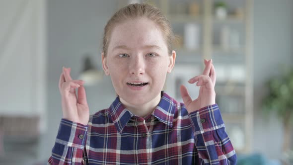 Close Up of Young Woman Optimistic With Fingers Crossed