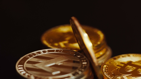 Shot of Bright Litecoin and Golden Bitcoins Rotating on Dark Background